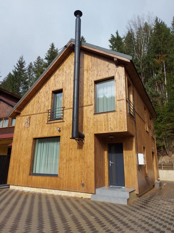 a building with a pole on the side of it at ALEXANDER Ski Lake View in Beliş