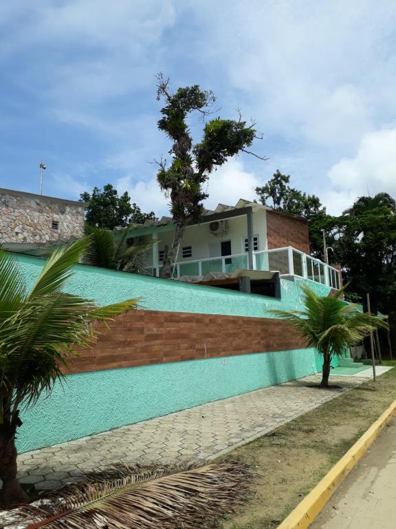 a house with a blue wall at CASA DO PESCADOR in Peruíbe