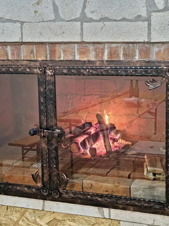 an ornate fireplace with a fire in it at Apartman BARIŠIĆ 2 in Kupres
