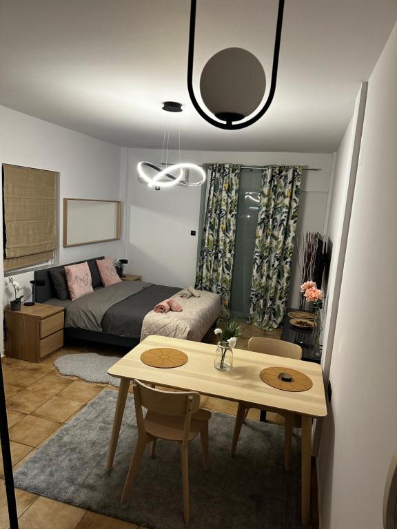 a bedroom with a bed and a table in a room at Νεάπολη in Larisa