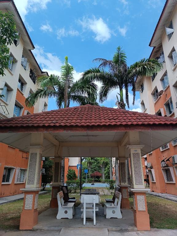 a pavilion with chairs and a table in front of a building at M.FR Homestay Pangsapuri Putra Damai in Putrajaya