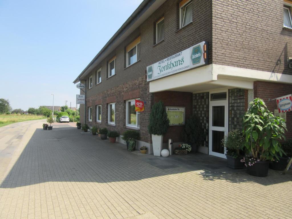 a brick building with a sign on the side of it at Hotel Restaurant Jonkhans in Rees