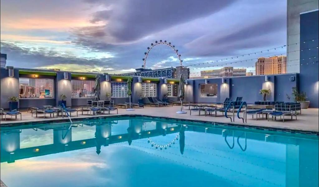 a hotel pool with a view of the city at Luxury 1BD/1BTH Suite at Platinum Hotel *STRIP VIEW in Las Vegas