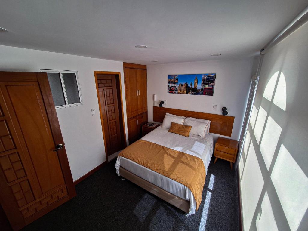 Postel nebo postele na pokoji v ubytování Hotel Estación Sabana