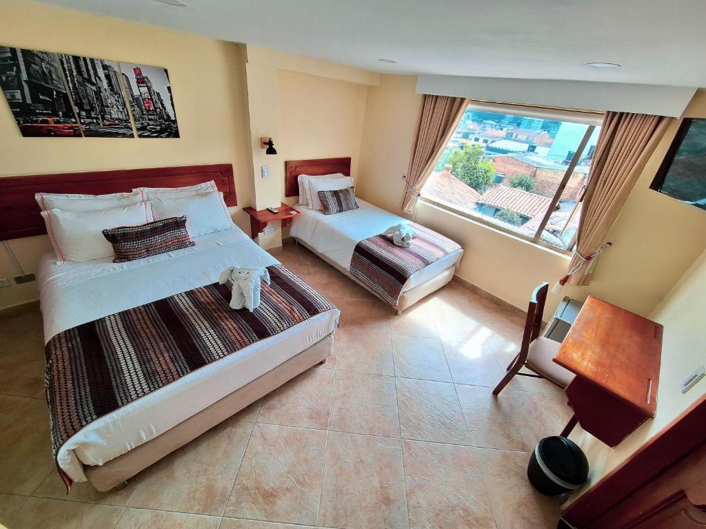 Postel nebo postele na pokoji v ubytování Hotel Estación Sabana