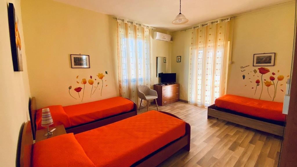A bed or beds in a room at La Bouganville B&B