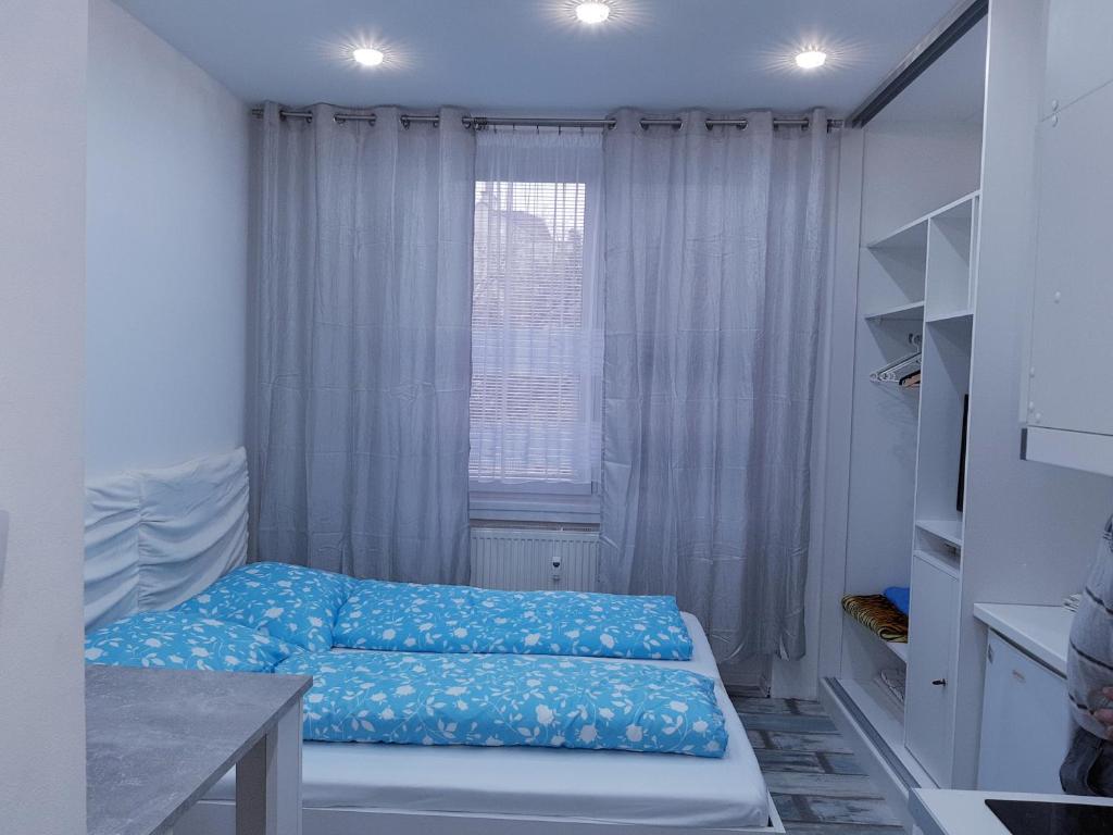 a small room with a bed in front of a window at Apartment Bratislava center in Bratislava