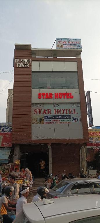 a group of people sitting outside of a star hotel at STAR HOTEL in Bahādurgarh