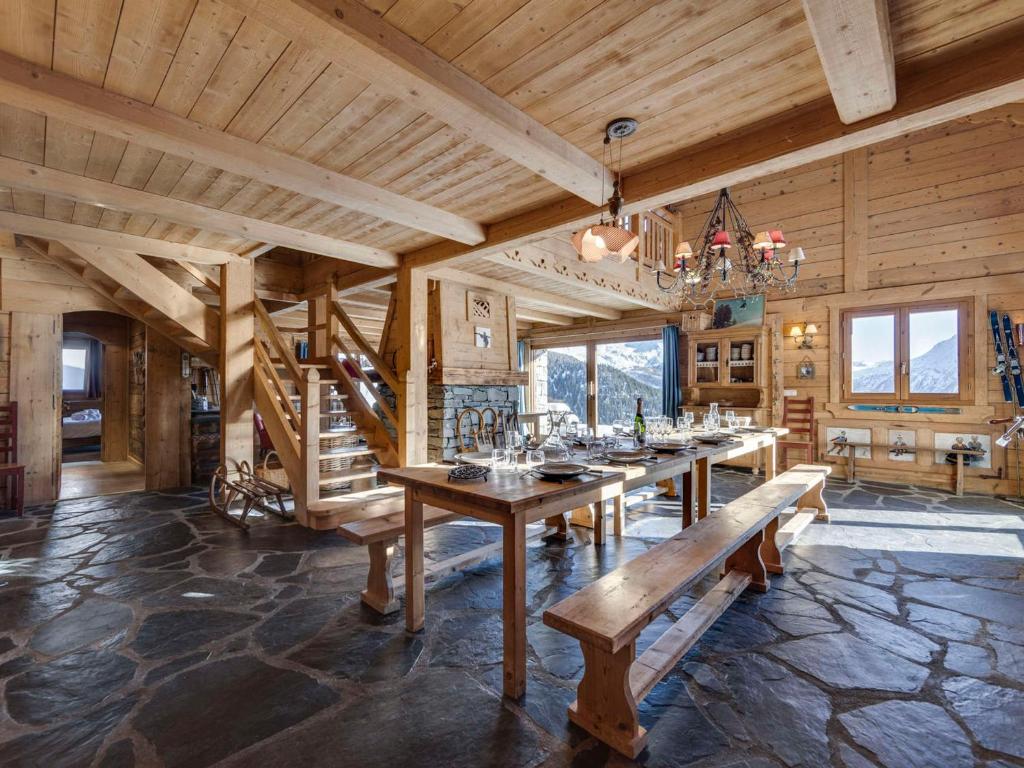 a dining room with a long table and benches at Chalet Montvalezan-La Rosière, 7 pièces, 14 personnes - FR-1-690-22 in Montvalezan