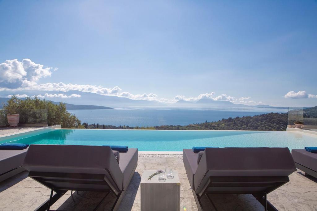 a swimming pool with a view of the water at Rachi Sea View White Villa in Episkopos