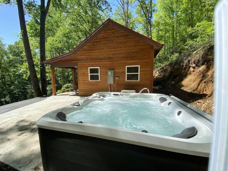 a jacuzzi tub in front of a house at Couple Retreat Cabin-near Smoky Mountain Railroad-Hot Tub in Bryson City