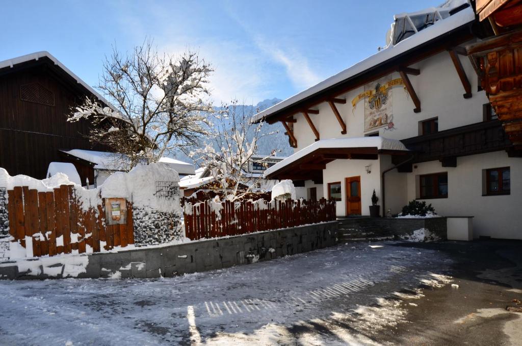 une maison avec une clôture recouverte de neige dans l'établissement Ferienhaus Ban Brösign, à Umhausen
