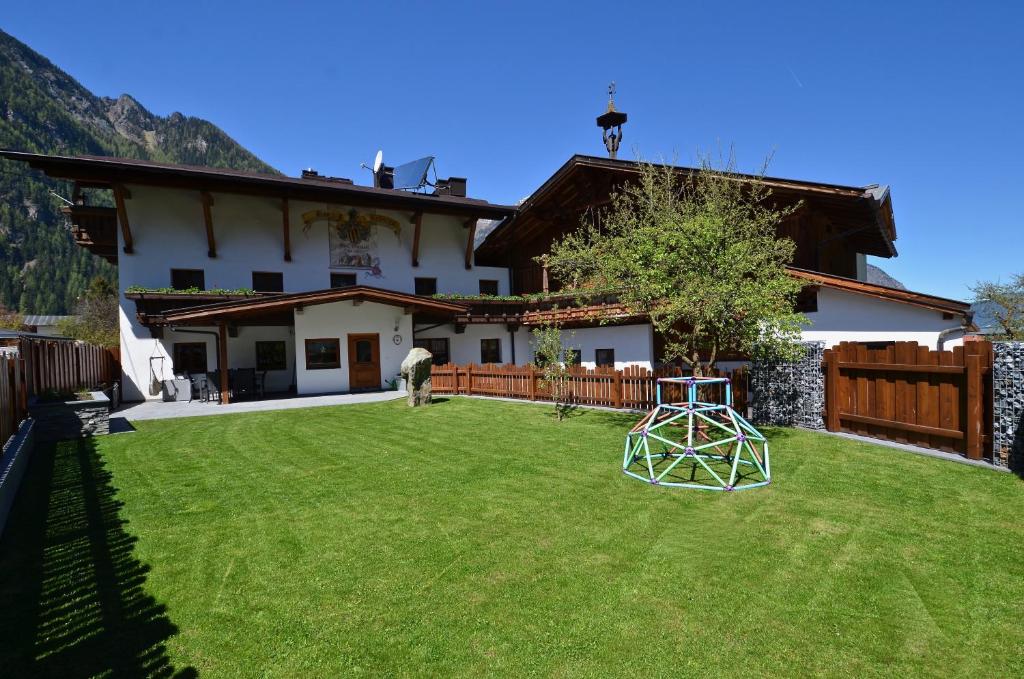 a house with a large yard with a yard at Ferienhaus Ban Brösign in Umhausen