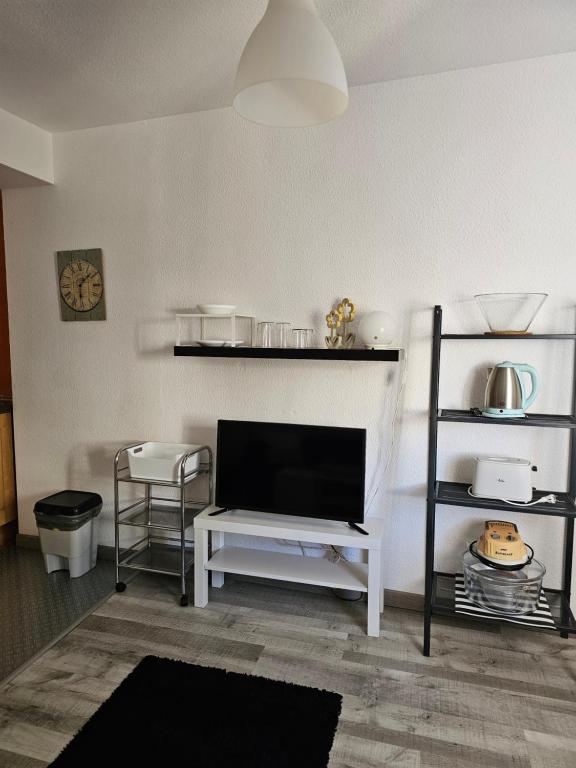 a living room with a flat screen tv and shelves at Apartamentos La Mar in Altea