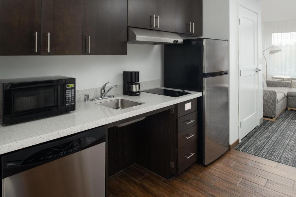 a kitchen with a sink and a microwave at TownePlace Suites by Marriott Olympia in Olympia