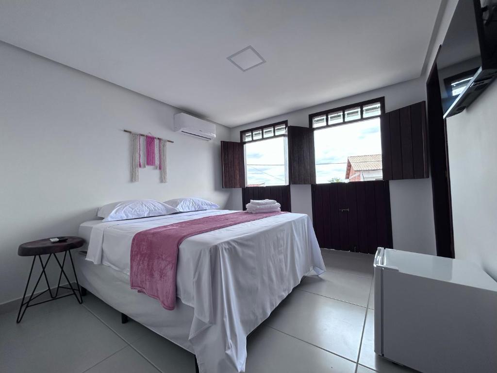 Cama ou camas em um quarto em Pousada Estrelar