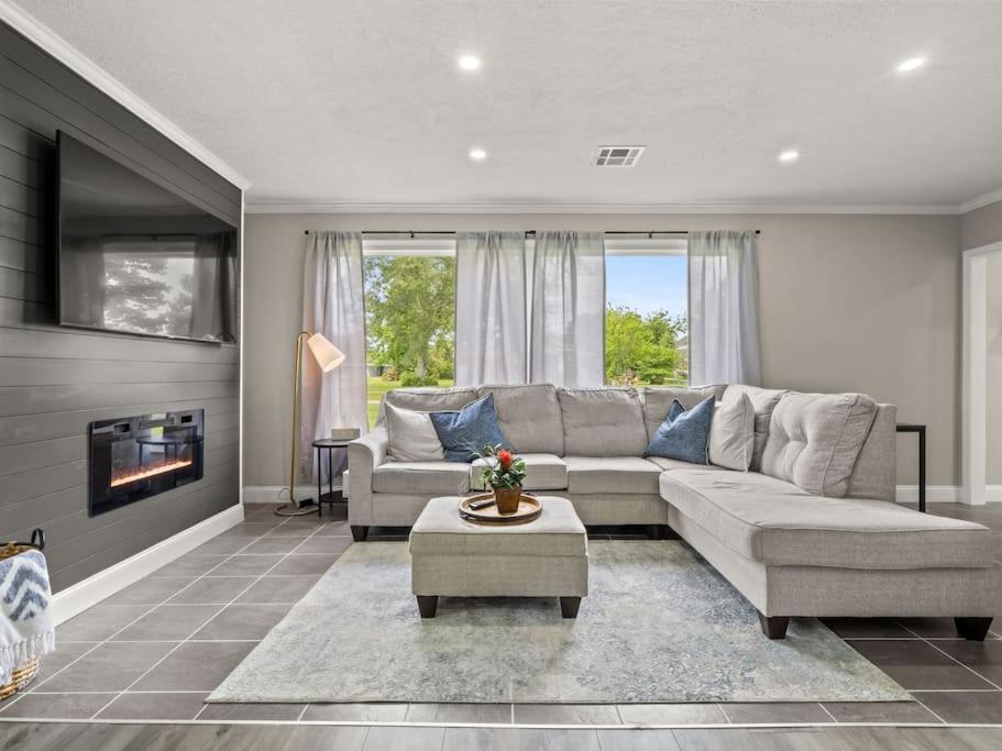 a living room with a couch and a fireplace at Beautiful 3 Bedroom Home in Lake Charles