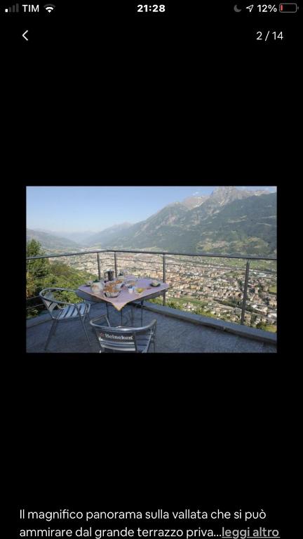 a picture of a balcony with a table and chairs at La stanza dei segreti in Aosta