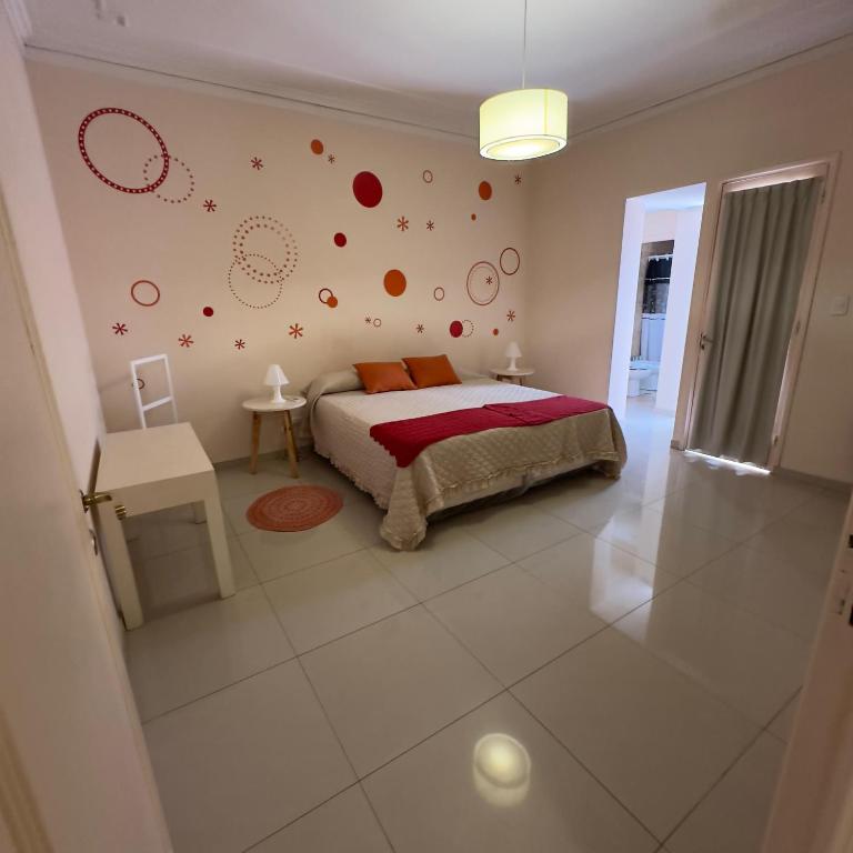 1 dormitorio con cama y planetas en la pared en Depto moderno a metros de los portones del parque sobre calle Boulogne Sur mer en Mendoza