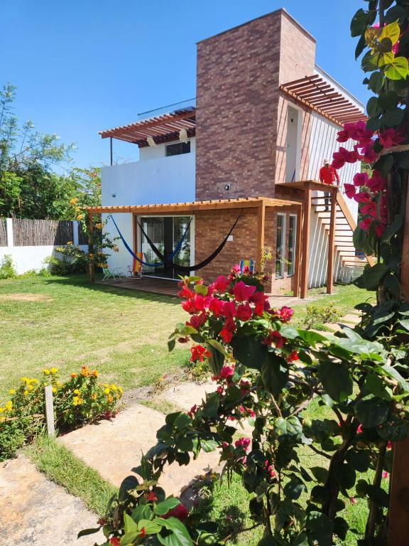 a house with a garden with flowers in the yard at VILA DO RIO in Santo Amaro