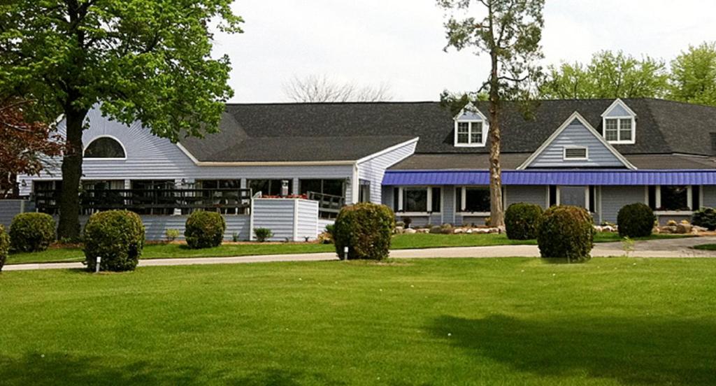 a house with a green lawn in front of it at The Lodge at Leathem Smith in Sturgeon Bay