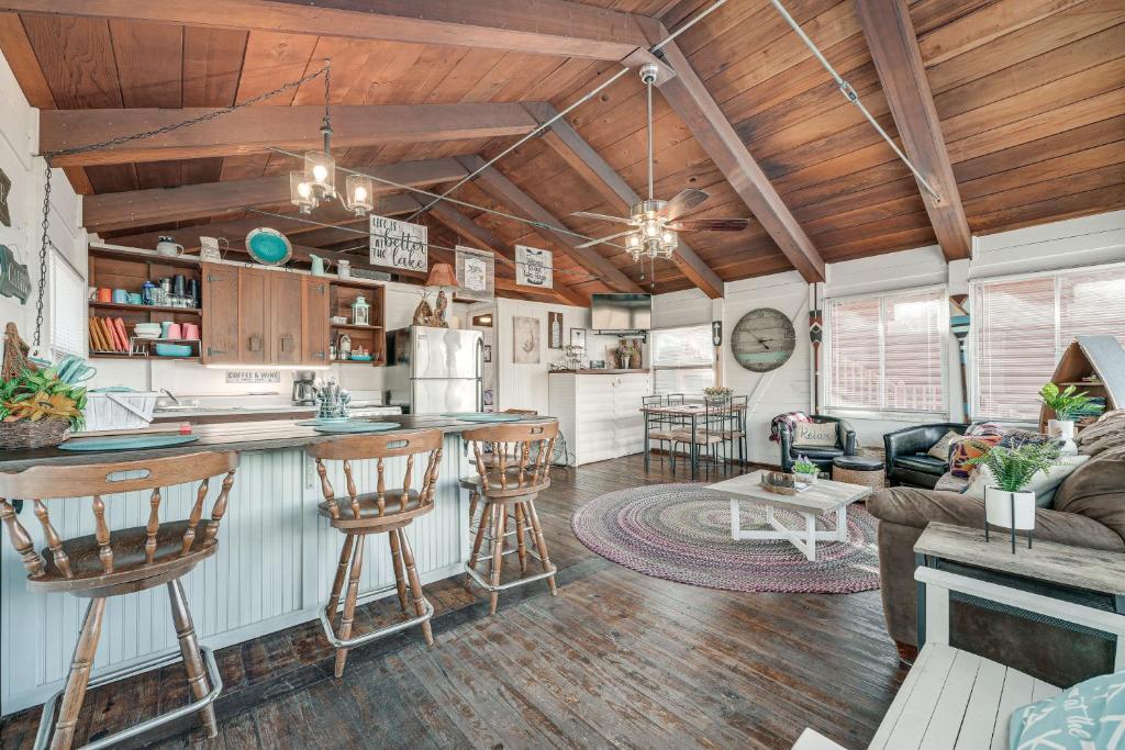 a kitchen and living room in a tiny house at Kimberling City Cabin 5 Min Walk to Lake in Kimberling City