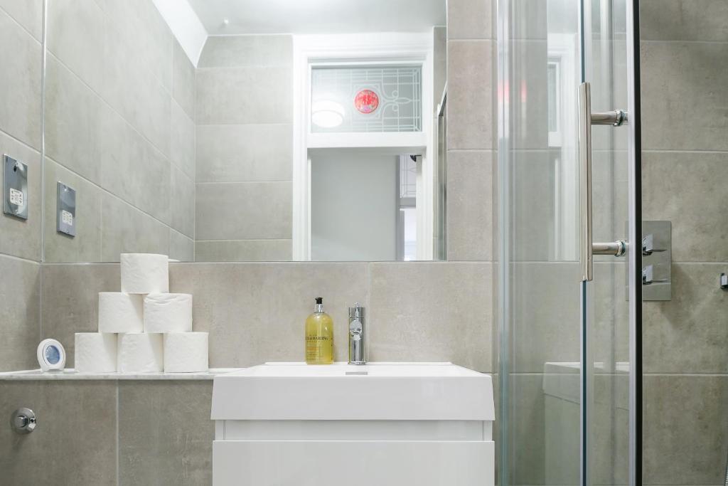 a bathroom with a sink and a shower at kings cross St Pancras luxury apt in London