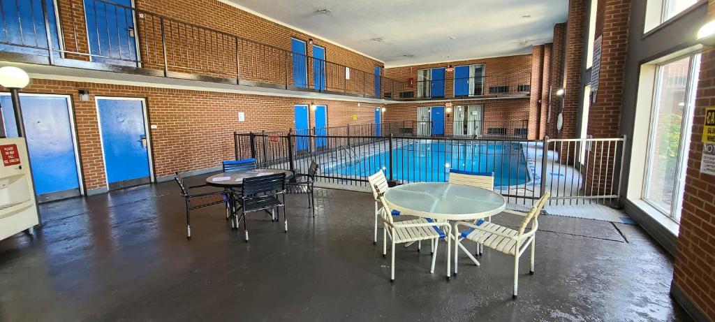 a room with a table and chairs and a swimming pool at Fairview Inn & Suite in Jonesboro