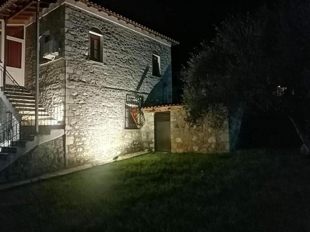 a building with a door in the yard at night at Parnassos cottage in Mavronérion