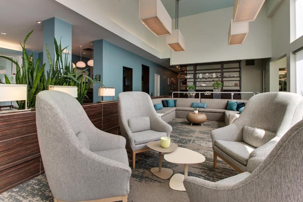 a lobby with chairs and a couch and a table at Element Ewing Princeton in Ewing