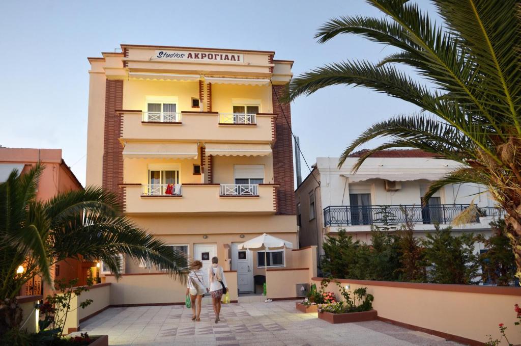 a man standing in front of a building at Studios Akrogiali in Limenaria