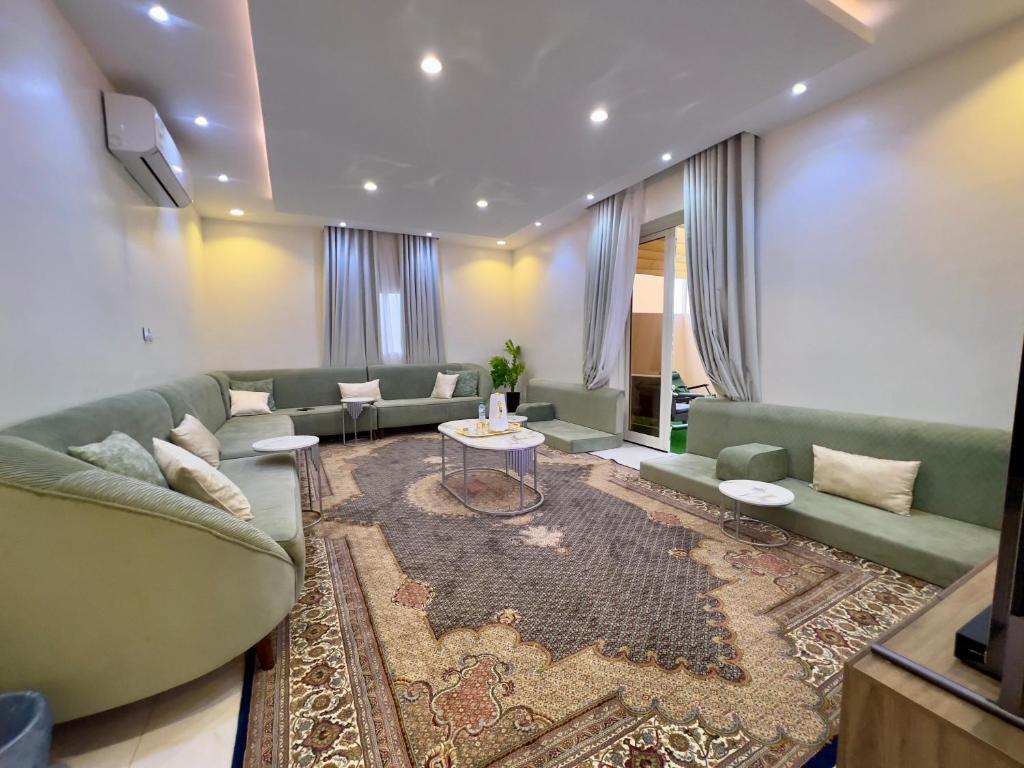 a living room with a couch and a table at شقة العقيق عروة alaqeeq apartments in Medina