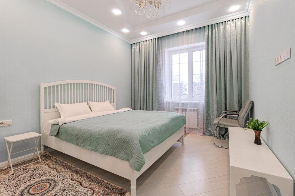 a white bedroom with a bed and a window at Венский Квартал-29 Apartments- Expo, Mega Silky Way in Prigorodnyy