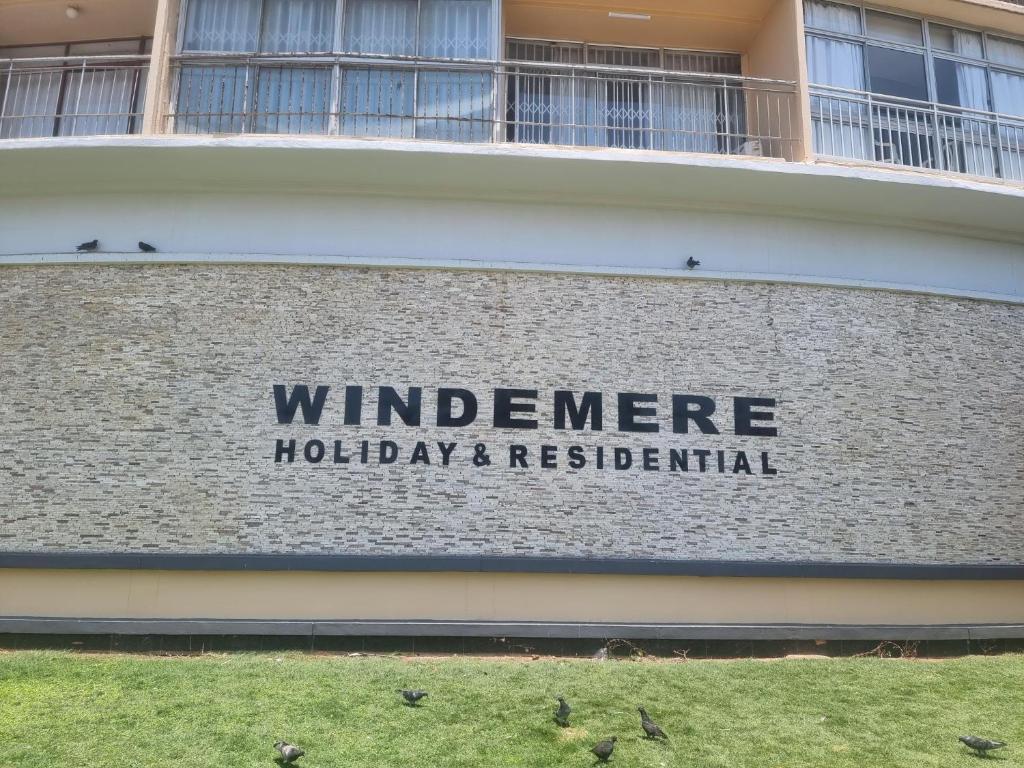 a sign on the side of a building at NO: 75 WINDEMERE HOLIDAY FLAT in Durban