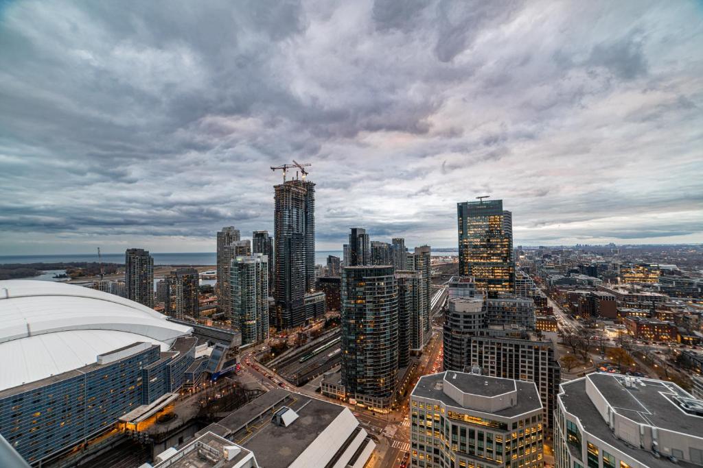 an aerial view of a city with tall buildings at Luxury Condo w/Mesmerizing Sunset Views & FREE Parking in Toronto