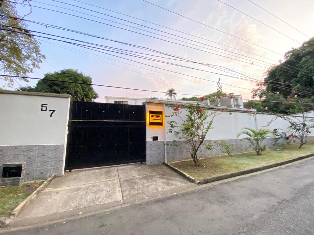 a house with a black gate on a street at Babilla Suites in Cali