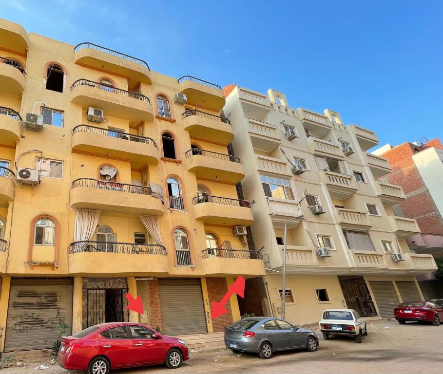 a large apartment building with red arrows in front of it at Hurghada City Apartment2 in Hurghada