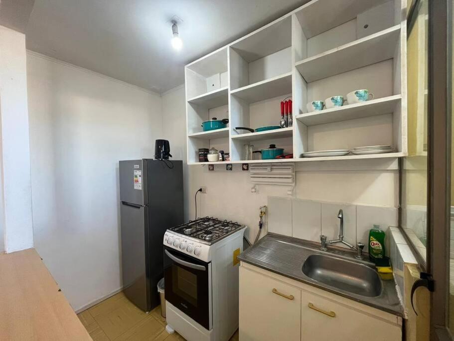 a small kitchen with a sink and a refrigerator at Apartamento amoblado 338 Ovalle in Ovalle