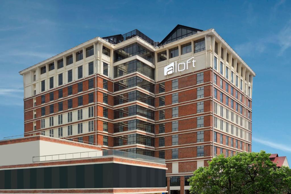 a tall building with a aktion sign on it at Aloft Kathmandu Thamel in Kathmandu