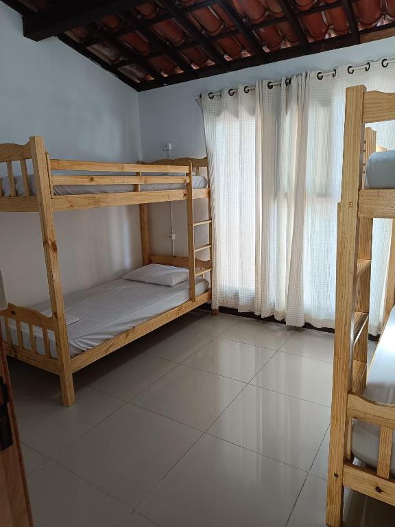 Postel nebo postele na pokoji v ubytování Ôxe Uai Hostel