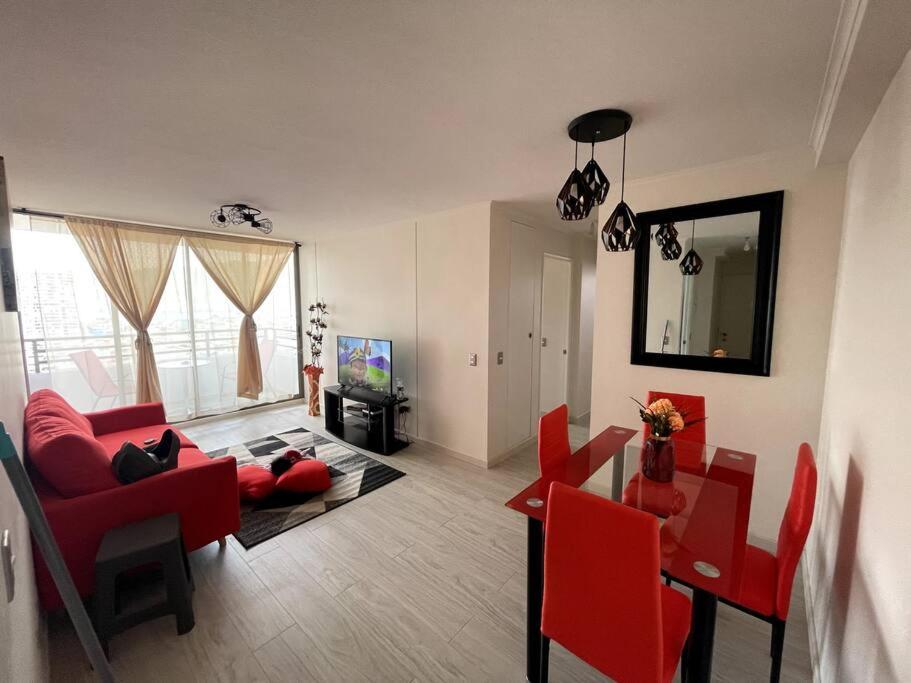 a living room with red chairs and a red couch at Arriendo departamento Amunategui in Iquique