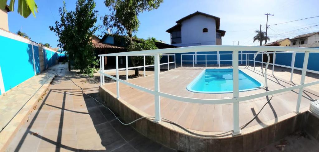 around swimming pool with a cover on a patio at casa do serramar in Rio das Ostras