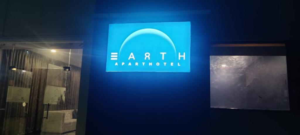 a blue sign on a wall in a room at Earth Inn in Chennai