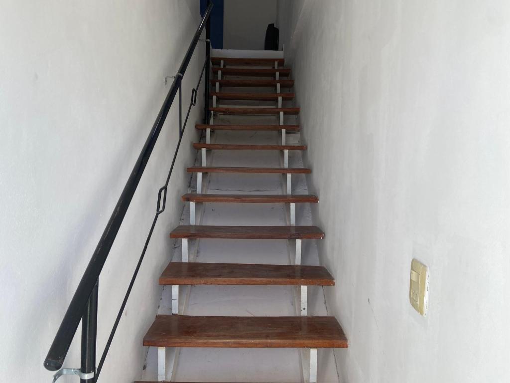 a staircase with wooden steps in a white wall at La Mía Casa Playa Union in Playa Unión