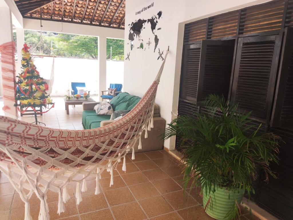 a hammock in the living room of a house at Hotel Pousada Farol de Manaíra in João Pessoa