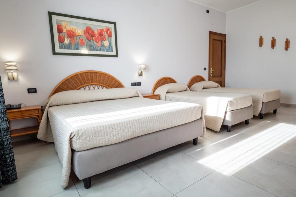 Postel nebo postele na pokoji v ubytování Hotel Corallo