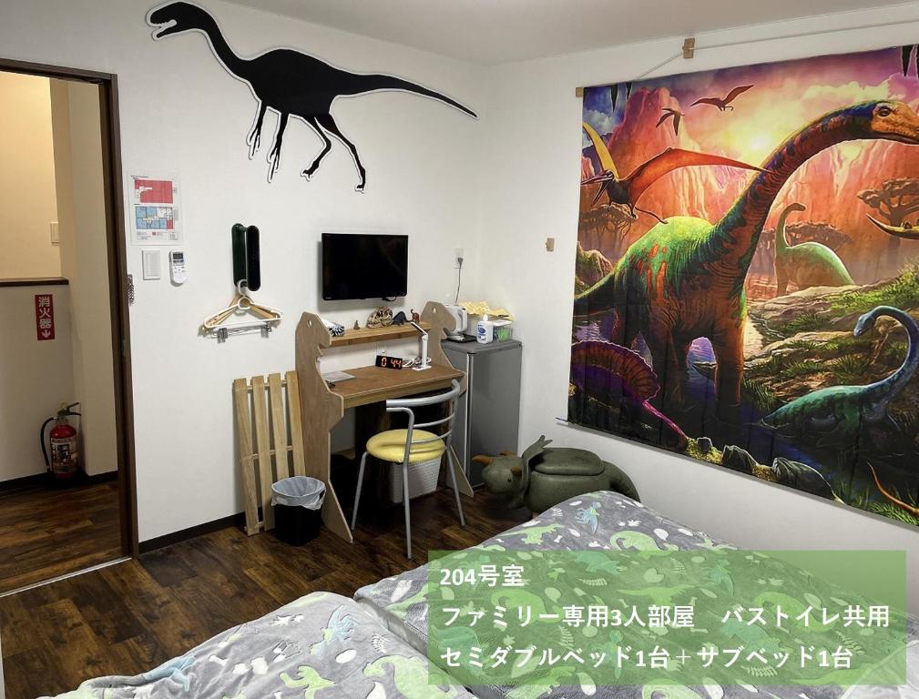 a bedroom with a dinosaur painting on the wall at 11月フルリフォーム 12月オープン恐竜一色ゲストハウスDinosaur Guesthouse in Katsuyama