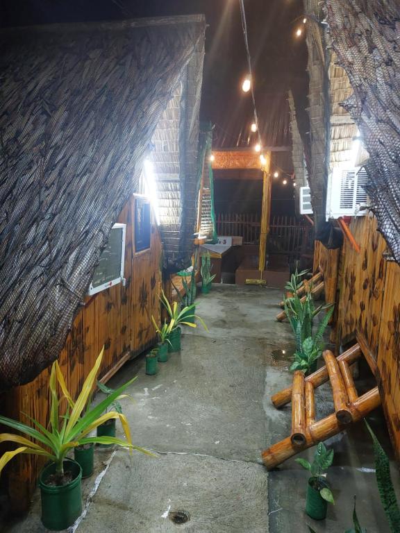 a room with a wooden fence and some plants at Kua's Pad Batangas Kubo in Lian