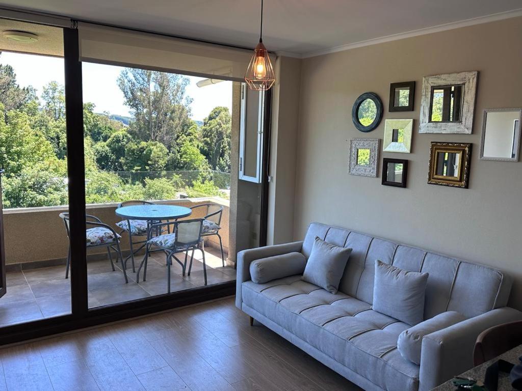 a living room with a couch and a table at Lindo Departamento en Costanera de Villarrica in Villarrica