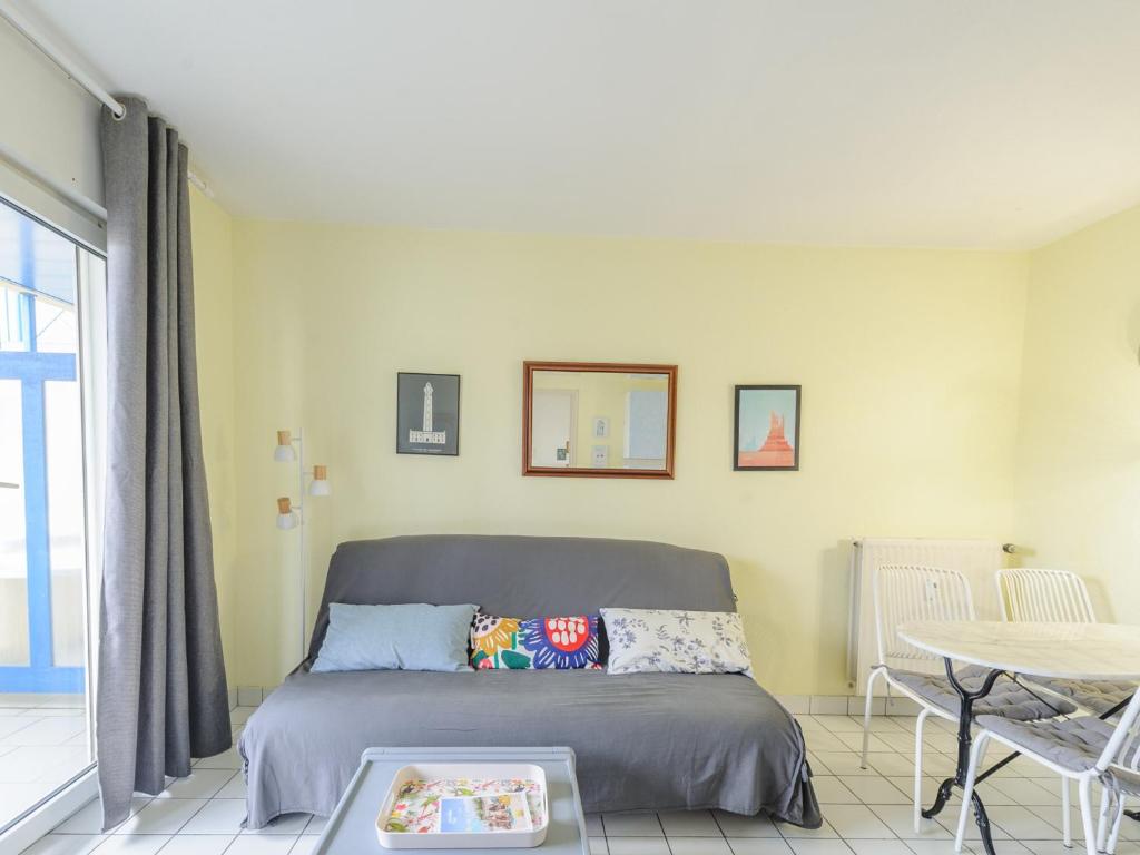 a bedroom with a bed and a table in a room at Appartement T2 à 50m de la plage avec piscine et terrasse - Châtelaillon-Plage, 4 personnes - FR-1-535-50 in Châtelaillon-Plage